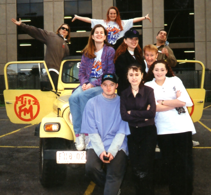Some of the Hitz FM promo team for Broadcast 5, April 1995.
Pictured standing on the yellow Jeep Renegade promotions vehicle. Location of the photo is the carpark of the Hitz FM St Kilda Road studios.